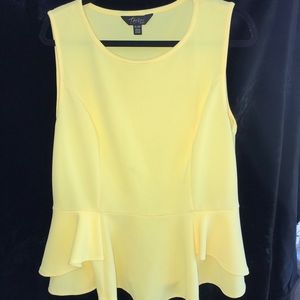 Yellow peplum shirt.